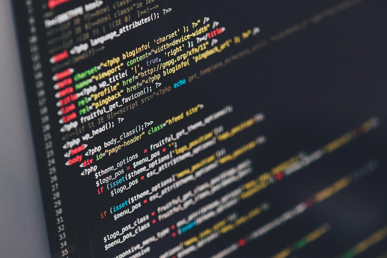 Modern programming workspace with multiple monitors and code